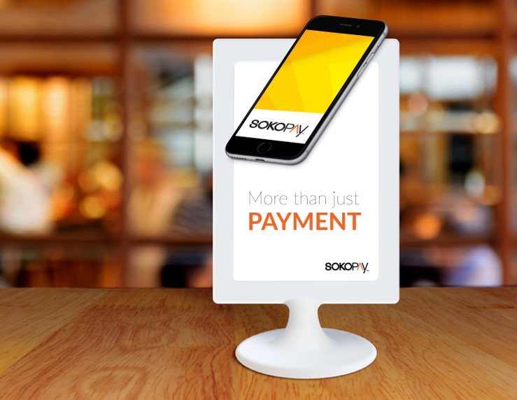 SokoPay mobile payment campaign displayed in a restaurant